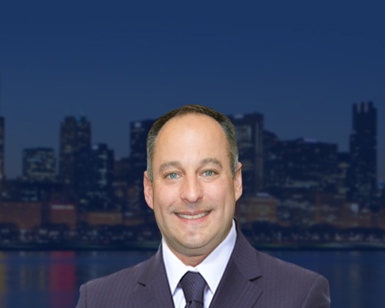 Profile picture of David L. Freidberg in a business suit standing with a city skyline in the background at night.