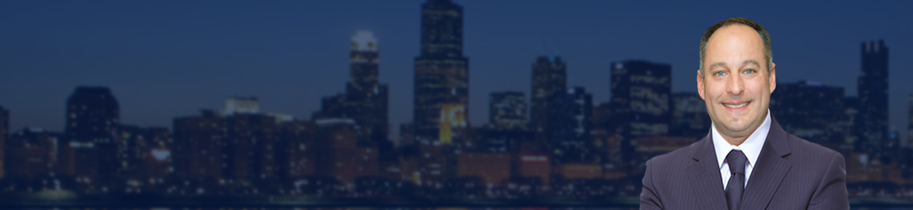 Profile picture of David L. Freidberg in a business suit standing with a city skyline in the background at night.